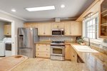 Full size stainless steel appliances and custom cabinetry